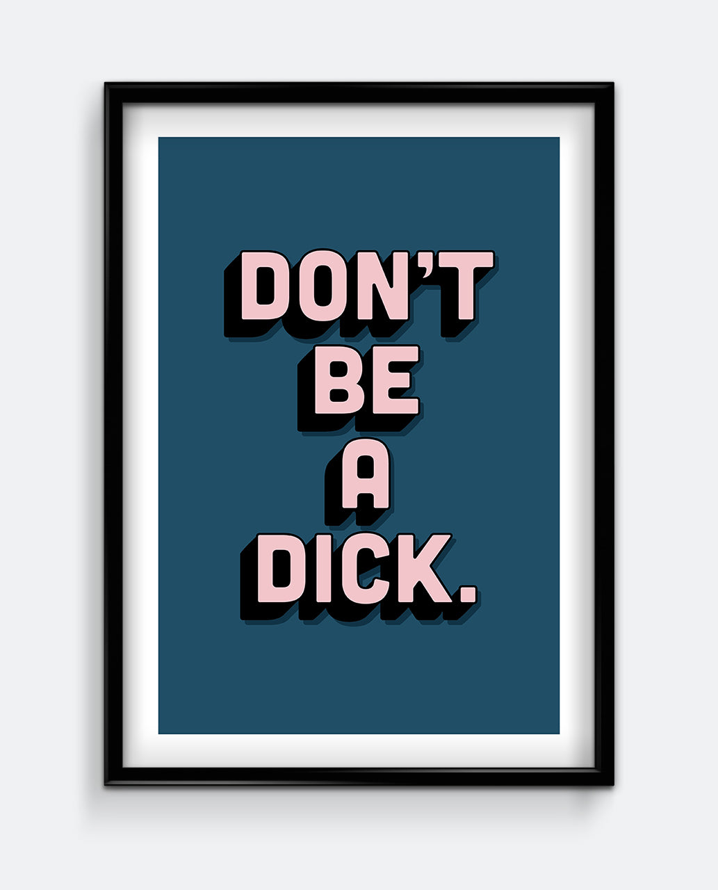This image features a framed art print with the bold statement "DON'T BE A DICK" printed in pink capital letters on a dark teal background. The artwork is encased in a simple black frame, enhancing its modern aesthetic.