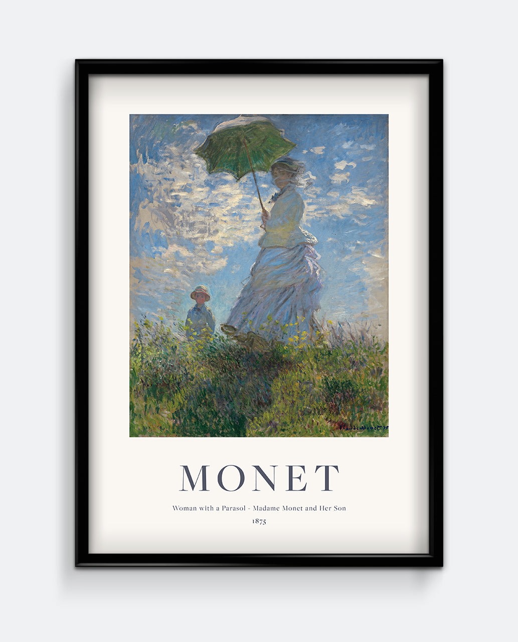 A framed art print of 'Woman with a Parasol – Madame Monet and Her Son' by Monet, featuring a woman and a child with a parasol against a blue sky.