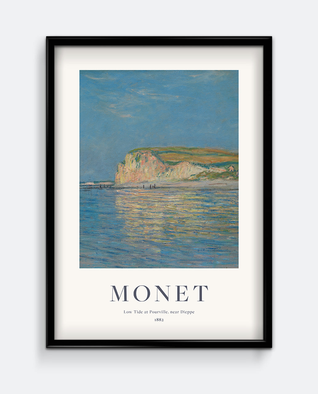 A framed print of 'Low Tide at Pourville, near Dieppe' by Monet, depicting a coastal landscape with a clear blue sky and reflective water.