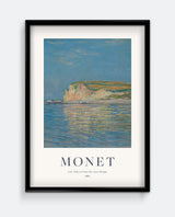 A framed print of 'Low Tide at Pourville, near Dieppe' by Monet, depicting a coastal landscape with a clear blue sky and reflective water.